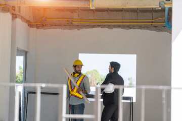 Architect and engineer foreman in helmet working on a building site,Civil engineer project...