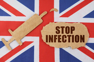 On the flag of Great Britain, the figure of a syringe and cardboard with the inscription - STOP INFECTION