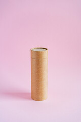 Craft tube for storing pencils and pens. The tuba stands on a pink background. Eco-friendly cardboard boxes