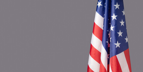 The American flag is on the right side on a gray background
