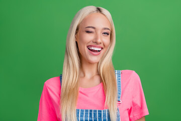 Photo of nice cheerful pretty positive lady toothy smile wink eye wear striped overall isolated...