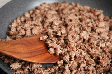 Cooking minced meat in frying pan, closeup