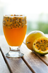 Maracuja fresh juice with seeds in glass