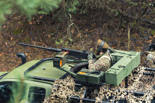 Surveying atmosphere for enemy threats on a British armed forces truck . High quality photo
