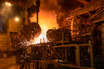 Pouring molten metal into a metallurgical electric arc furnace
