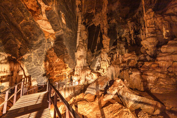 The wooden walking path throughstalactite and stalagmite in Phu Pha Petch cave at Thailand