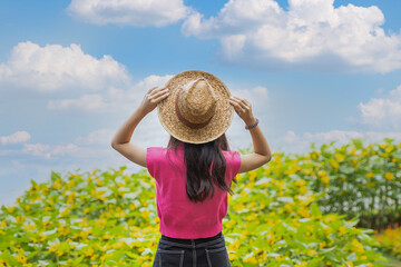 Young traveler woman in summer vacation wearing straw hat, enjoying the view at the landscape.