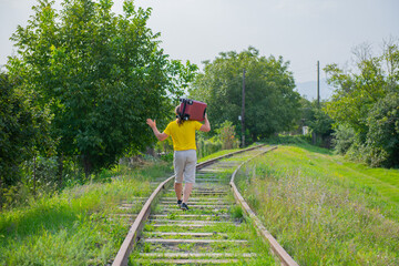 all one man on his shoulder carries a red suitcase