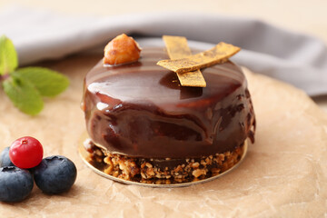 Plate with delicious chocolate cake and berries on light background