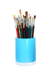 Set of paintbrushes in holder on white background