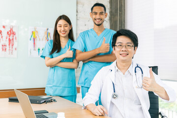 Confident young Asia doctor in white medical uniform with stethoscope looking at camera and smiling  health hospital.Portrait of a smiling doctor in office.