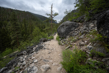 Hiking trail on a ledge with large boulders
