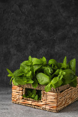 Wicker basket with mint on table