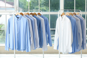 Racks with clean shirts after dry-cleaning
