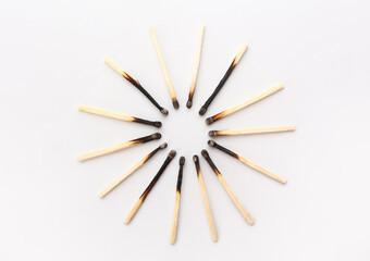 Frame made of burnt candles on white background. Concept of work burnout