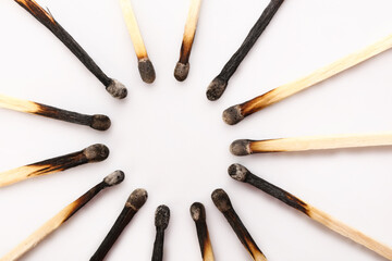 Frame made of burnt candles on white background, closeup. Concept of work burnout