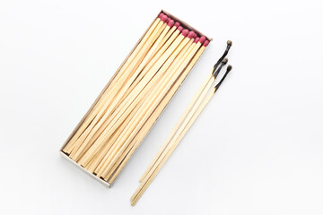 Whole and burnt fireplace matches on white background. Burnout concept