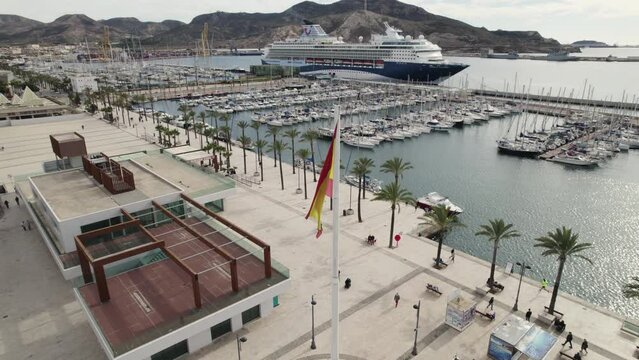 Aerial orbit around flagpole with Spanish flag, Cartagena port square