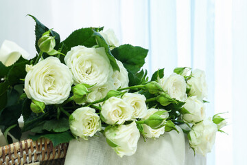 Bouquet of beautiful fresh roses in room, closeup
