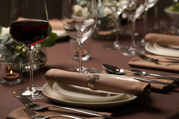 Glass of delicious wine and elegant table setting in restaurant