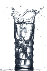 Glass of clear water with splash isolated on white