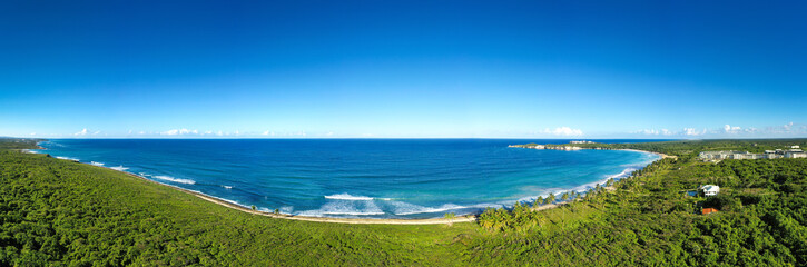 Macao beach with sandy coastline, turquoise water and stone cliff. Dominican Republic. Aerial panorama view