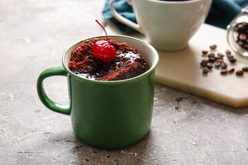 Cup with tasty chocolate brownie on grey background