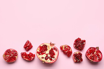 Pieces of fresh pomegranate on pink background