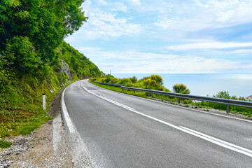 A beautiful road along the sea with steep cliffs.
