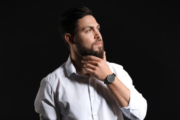 Stylish bearded man on dark background