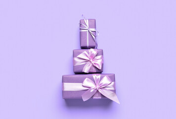 Different gift boxes with ribbons and bows on color background