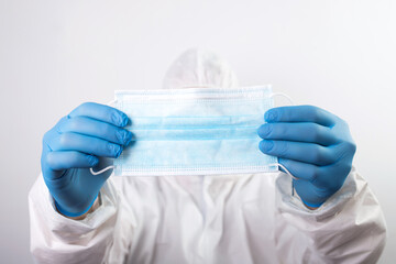Fototapeta premium Close up of doctor hand holding surgical face mask