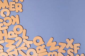 A set of wooden letters of the English alphabet on a colored background