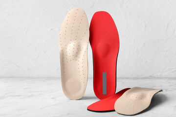 Orthopedic insoles on light background