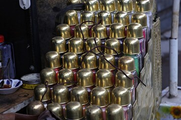 Decorative display of paint cans made of gold in the shoe shine chest