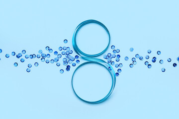 Figure 8 made of ribbon and sequins on color background. International Women's Day celebration