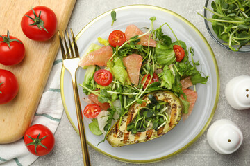 Delicious pomelo salad with grilled avocado served on light grey table, flat lay