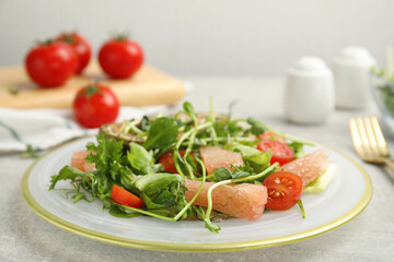 Fototapeta na wymiar Delicious pomelo salad served on light grey table, closeup