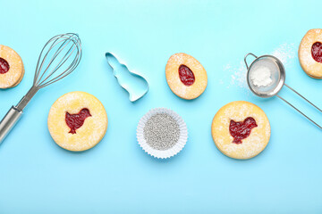 Delicious Easter cookies and utensils on blue background