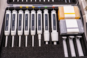Case with laboratory devices. Specialized laboratory instruments close-up. Plastic pipettes for...
