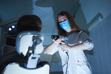 creepy dentist scares client with drill, fear and horror, Halloween. man is afraid of doctor, wants...