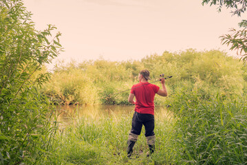 Fisherman throws a spinning view from the back.