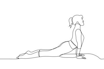 young woman in cobra pose doing yoga - one line drawing vector. concept yoga coach shows asana for stretching muscles, lady doing yoga at home