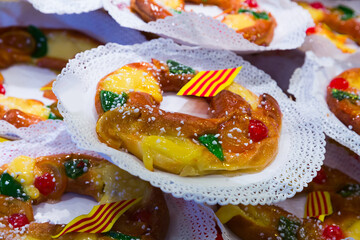 Delicious tortell (Coca de reyes) - ring shaped brioche decorated with sugared fruit and...