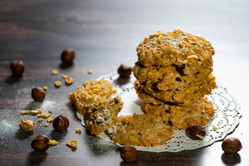 Homemade cookies with chocolate, nuts and milk on a wooden table and art background in the morning. Close. Breakfast.