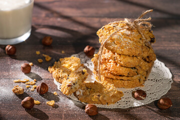 Homemade cookies with chocolate, nuts and milk on a wooden table and art background in the morning. Close. Breakfast.