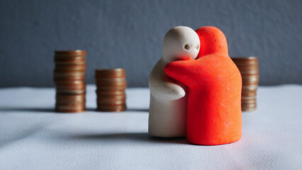 People hug on coin background.