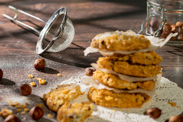 Homemade cookies with chocolate, nuts and milk on a wooden table and art background in the morning. Close. Breakfast.