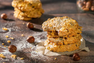 Homemade cookies with chocolate, nuts and milk on a wooden table and art background in the morning. Close. Breakfast.