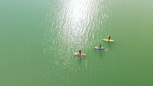 Poeple is paddling on sup board in the winter lake